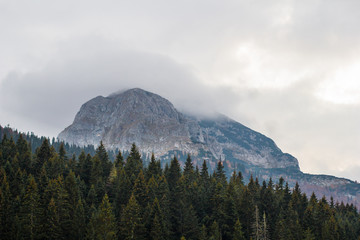 Bobotov kuk mountain in clouds surrounded by forest. Autumn in Montenegro, Black lake.