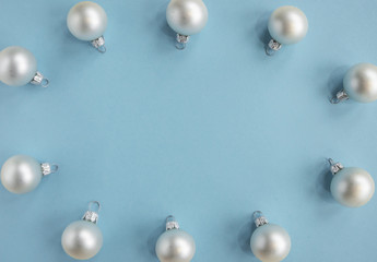 Christmas or new year flat lay with white balls on light blue background. Top view. copy space. 