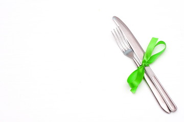 fork and knife on a white table.