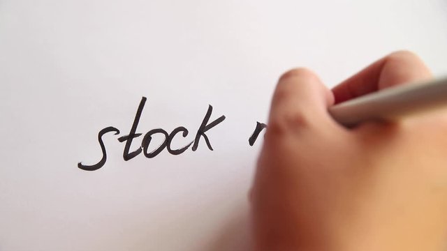 Hand writing Stock market on white paper