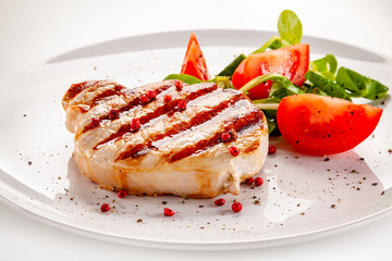 Grilled steak with vegetable salad on white background