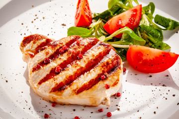 Grilled steak with vegetable salad on white background