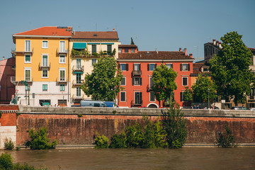 View of traditional residential buildings along the river promenade in Verona in Italy