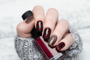 Burgundy manicure with a Scottish cage and dots pattern