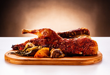 Roast duck on cutting board on white background