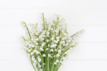 Lilly of the valley flowers bouquet on light background.