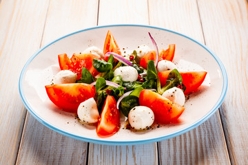 Caprese salad on wooden table