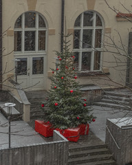 Fototapeta na wymiar Christmas tree and presents in light snowfall