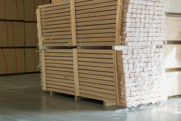 Warehouse tree. Pallets with wooden plates in a warehouse or in a hangar. Lumber production