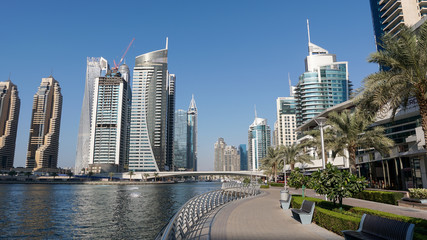 Fototapeta premium Day view of the Luxurious Dubai Marina in UAE taken at bright sunny day. Luxury lifestyle and travel.