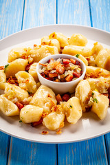 Potato noodles - dumplings on wooden background