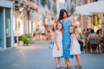 Obraz premium Mother with little cute daughters eating ice-cream outdoor