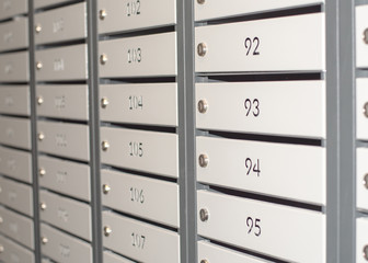 Gray mailboxes in an apartment building.