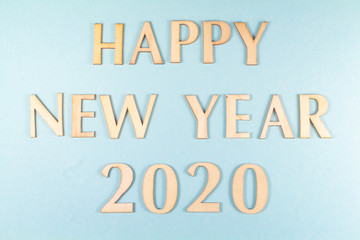 Happy new year and 2020 in wooden figures on blue background