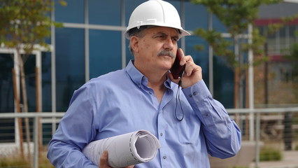 Mature architect talking on mobile phone