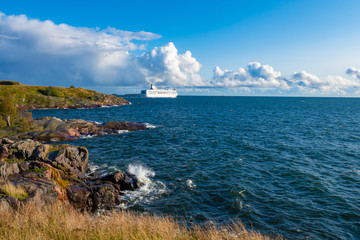 Finland. Helsinki. Baltic sea. Cruise ship goes on a journey. White ship on a rocky shore. Sea...