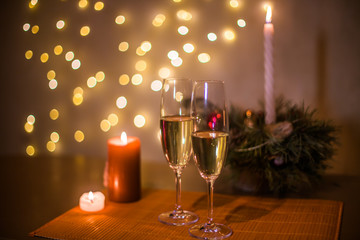 Christmas champagne on a table against the background of garlands