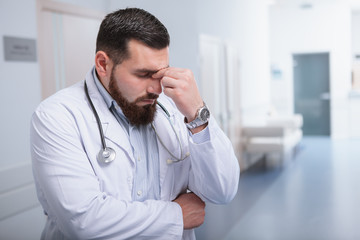 Bearded mature male doctor at the hospital