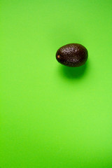 Row avocado on green background, creative food concept