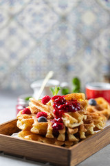 Homemade sourdough waffles with berry sauce for breakfast. The concept of proper nutrition. Selective focus, copy space.