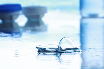 Tools for vision correction. Glasses and lenses with diopters on the background of splashes and...