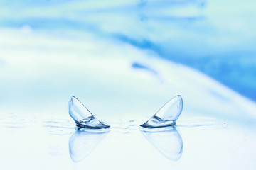 Tools for vision correction. Glasses and lenses with diopters on the background of splashes and...