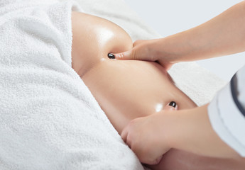 Masseur makes anti-cellulite massageon the legs, thighs, hips and buttocks in the spa. Overweight treatment, body sculpting.Cosmetology and massage concept.