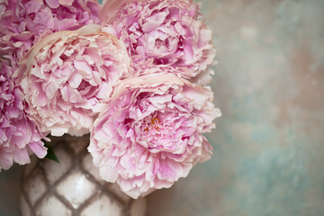 Pink peonies in a vase, fragment, close-up, blur.
