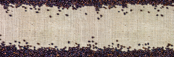 roasted coffee beans on jute fabric, background panorama banner