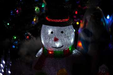 Snowman glows in the dark. A beautiful home decoration for Christmas. Festive figurine for home....
