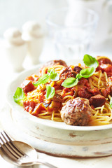 Spaghetti with meatballs and fresh basil. Bright background. 