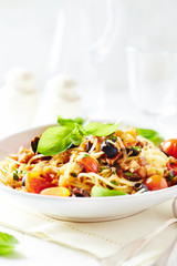 Spaghetti pasta with vegetable sauce.  Bright background