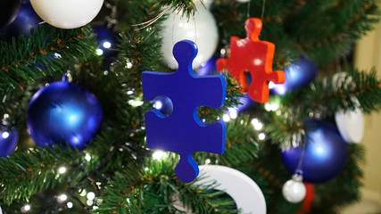 Christmas decorations on the tree. Blue and red puzzle.		
