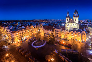 Fototapeta na wymiar Prague Old Town Square during christmas with beautiful city lights glowing in early night with blue sky