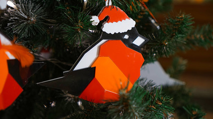 Christmas decorations on the Christmas tree. Bullfinch from the puzzle.
