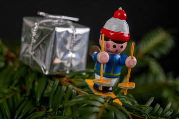 Christmas decorations on the green tree. Tinsels hung on a spruce twig.