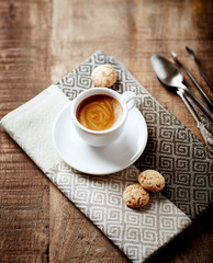 Cup of coffee with Amaretti Cookies on rustic wooden background. 