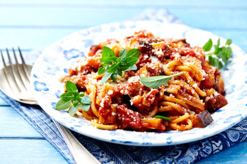 Spaghetti pasta with zucchini in a small bowl. Bright background.