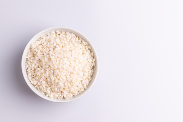 Italian Risotto rice on white background. Copy Space. Soft light. Latin term 
