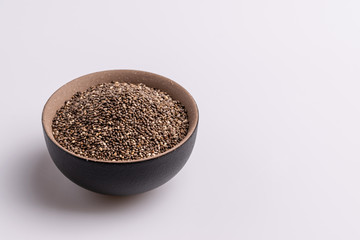 Chia seeds  isolated on white background, angle view, copy space, studio shot, soft light. Latin name (Salvia hispanica).
