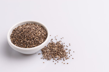 Chia seeds  isolated on white background, angle view, copy space, studio shot, soft light. Latin name (Salvia hispanica).