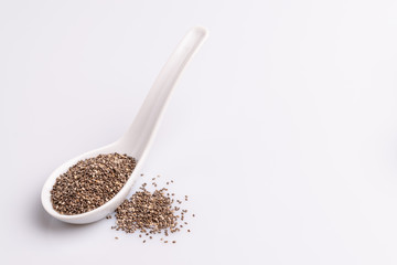 Chia seeds  isolated on white background, angle view, copy space, studio shot, soft light. Latin name (Salvia hispanica).
