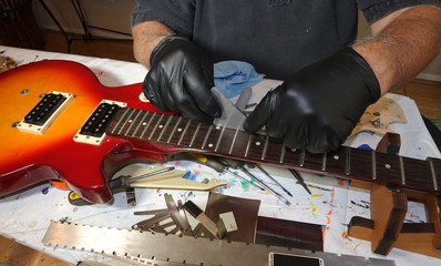 Guitar repair - checking the fret height and level with a rocker  tool