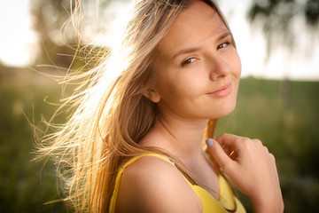 Portrait of young  woman with radiant clean outdoor on a spring/summer sunny day