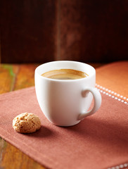 Amaretti (Italian biscuit) and a cup of coffee on dark background. Close up. 