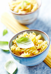 Uncooked pasta in ceramic bowl. Close up. 
