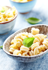 Uncooked pasta in ceramic bowl. Close up. 