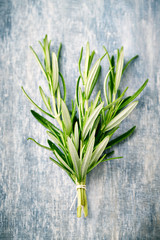 Fresh rosemary on rustic wooden background. Top ivew. 