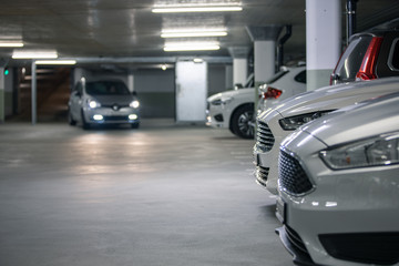 Underground parking. Cars parked in a garage with no people. Many cars in parking garage interior....
