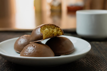 Honey bread cookie, typical Brazilian candy with cup of coffee on wooden background